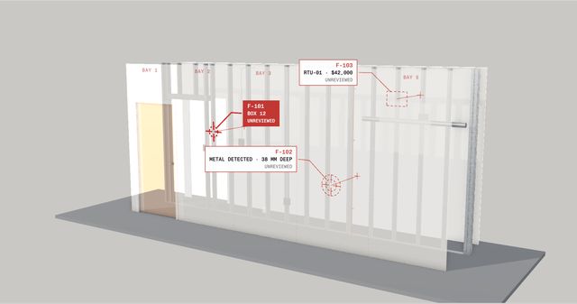 The demo wall with its layers opened, each red mark traced back to the framing and services behind it.
