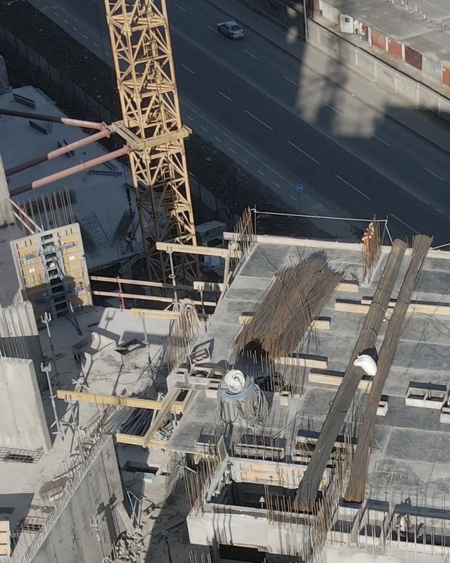 The tower crane rising past the building’s concrete core.